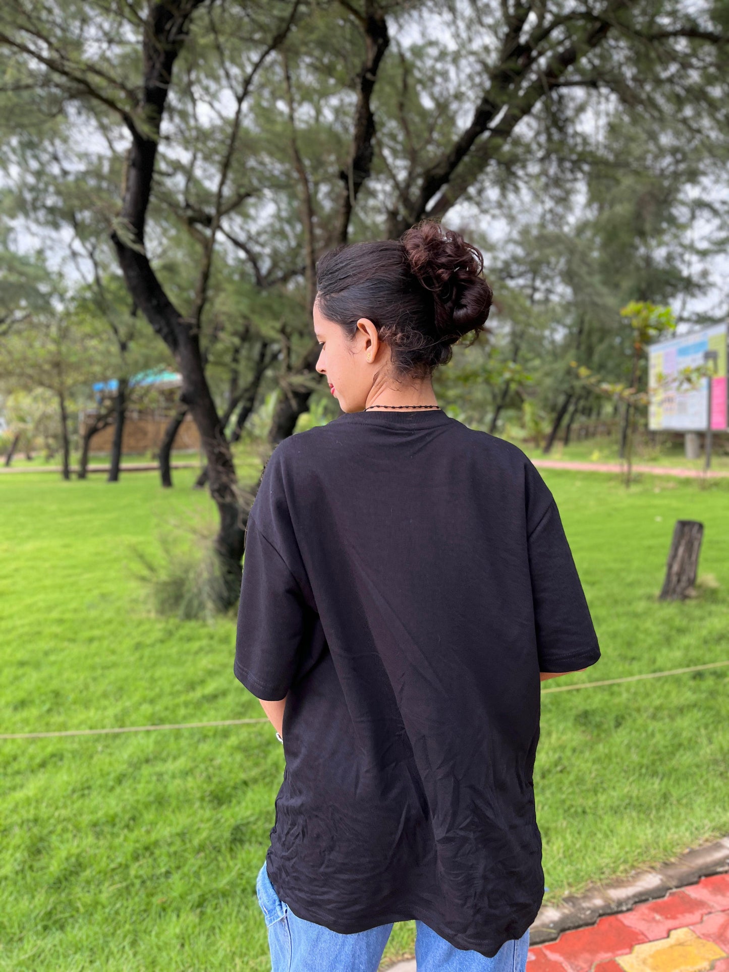 Red cherry in black oversized t-shirt