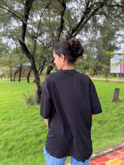 Red cherry in black oversized t-shirt