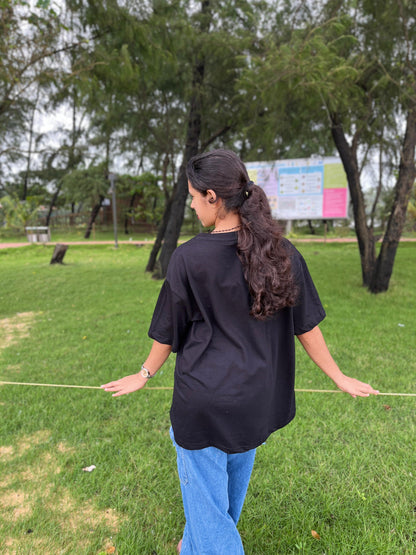 Red cherry in black oversized t-shirt